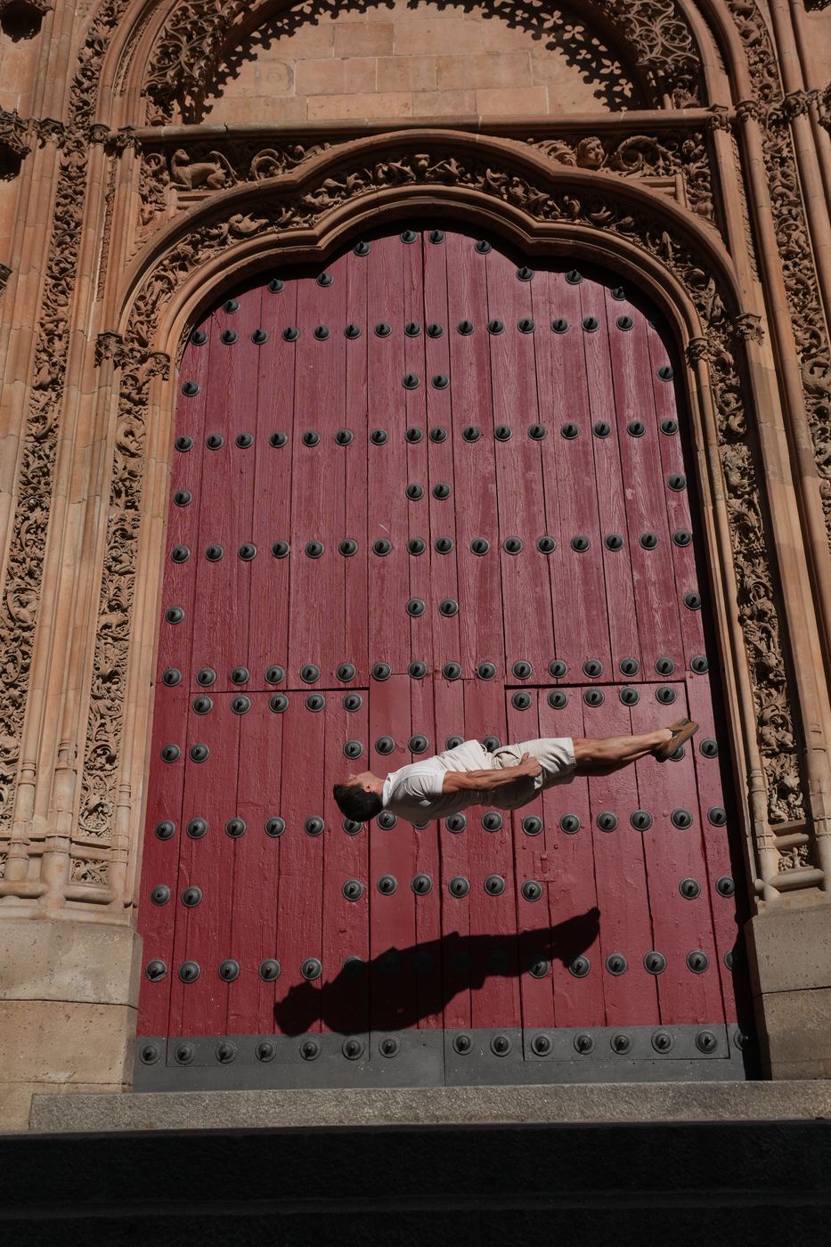 Flying past a carved red door