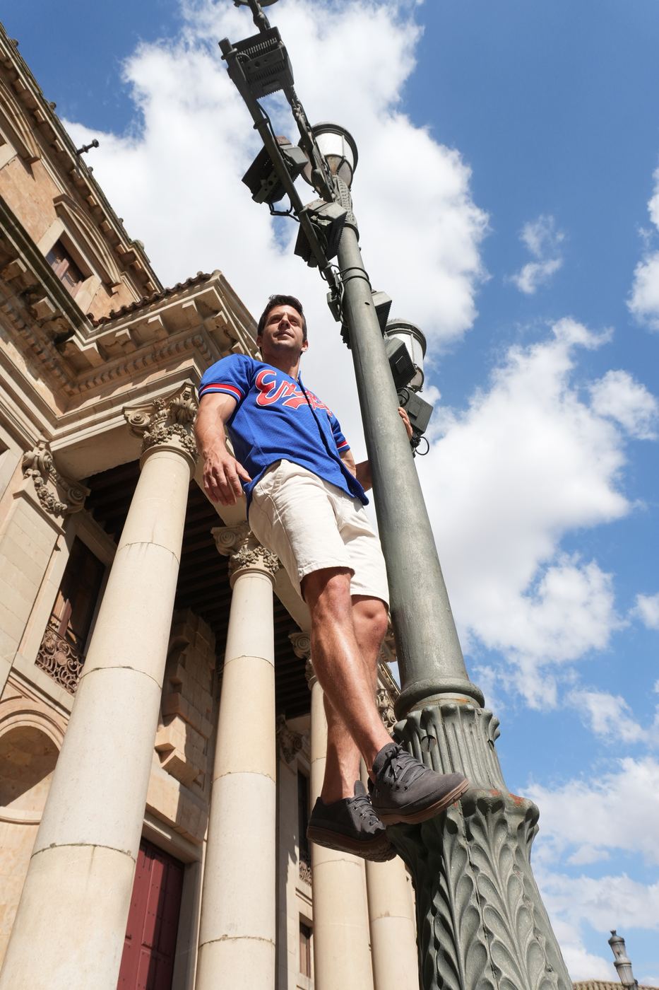 Hanging one-handed from a lamppost